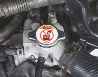 radiator cap about to be removed for a radiator flush near me